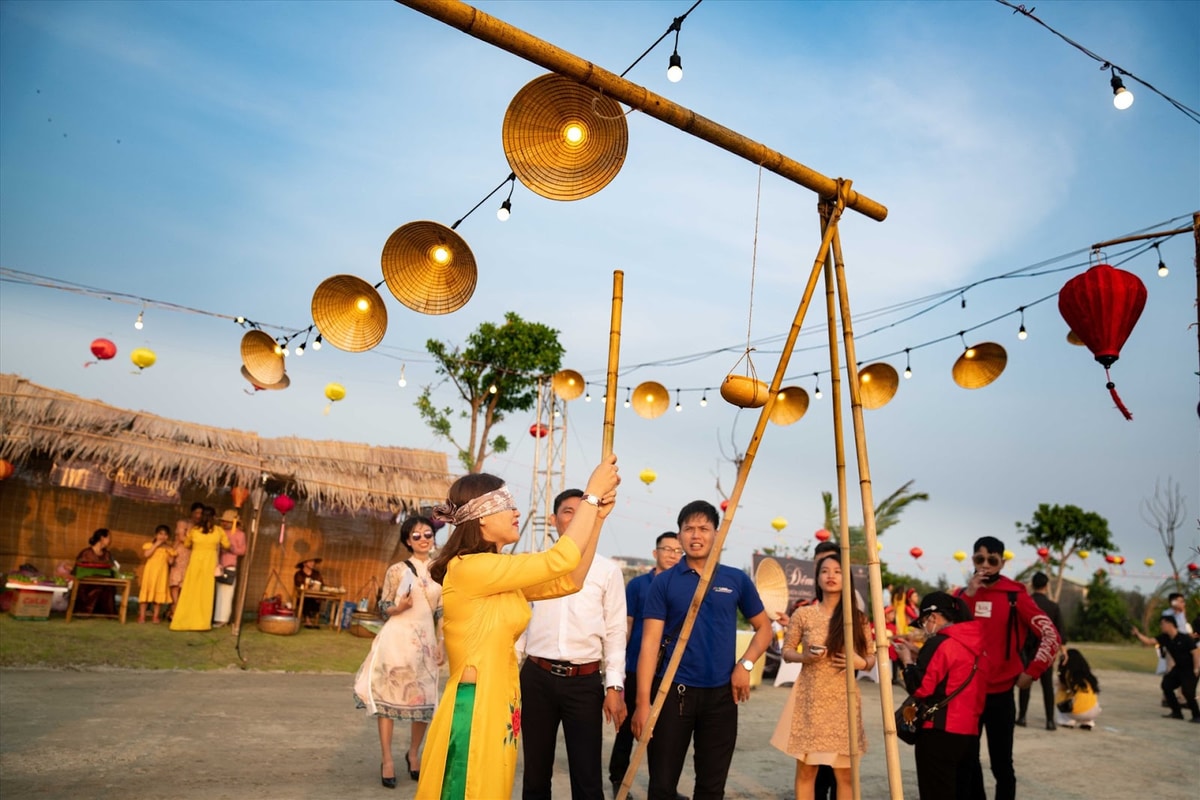 With eyes blindfolded and cheers from the crowd, players try to smash a hanging clay pot using only a bamboo stick